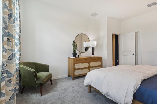 bedroom featuring light colored carpet, visible vents, and baseboards