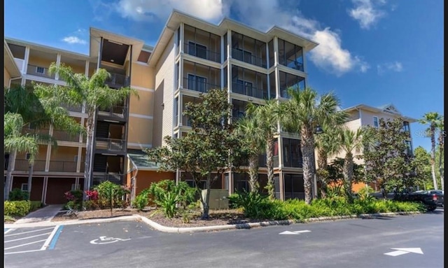 view of building exterior with uncovered parking