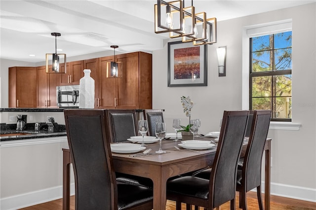 dining room featuring baseboards and wood finished floors