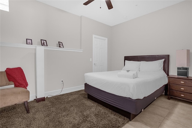 bedroom featuring a ceiling fan, light colored carpet, and baseboards