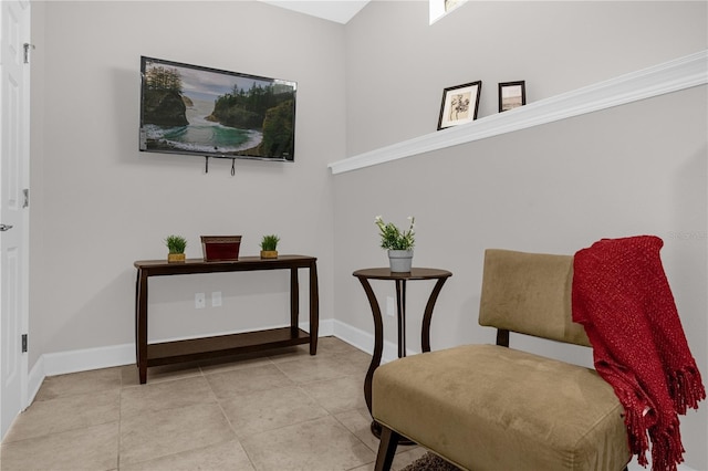 living area with light tile patterned flooring and baseboards