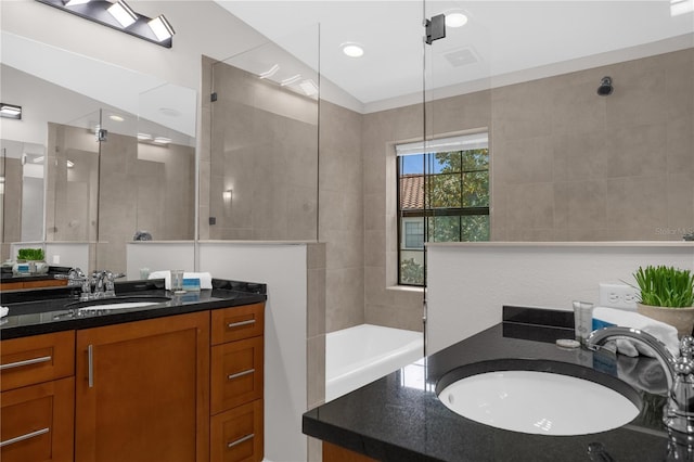 full bathroom with a bathing tub, visible vents, walk in shower, and vanity