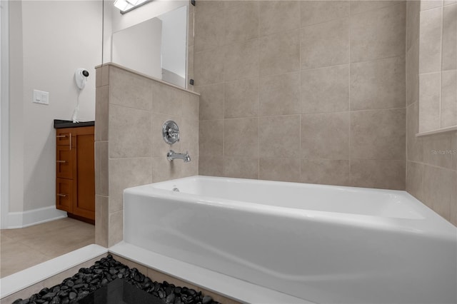 full bathroom featuring a tub, tile patterned flooring, tile walls, and vanity