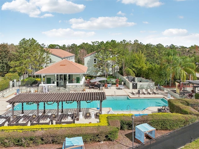 pool with a patio area, fence, and a pergola