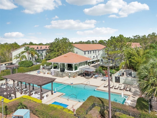 community pool with a patio area, fence, and a pergola