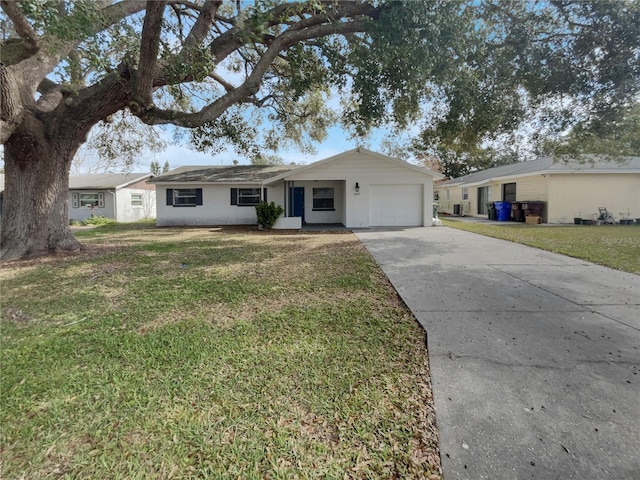 ranch-style house featuring driveway, a front lawn, and an attached garage