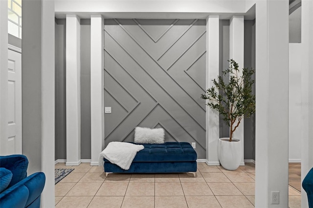 sitting room with baseboards and light tile patterned flooring