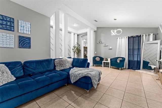 tiled living room featuring vaulted ceiling, a textured ceiling, a chandelier, and visible vents