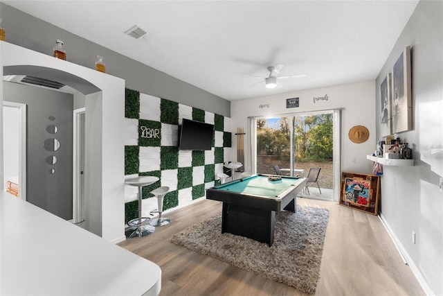 recreation room featuring arched walkways, ceiling fan, billiards, wood finished floors, and visible vents