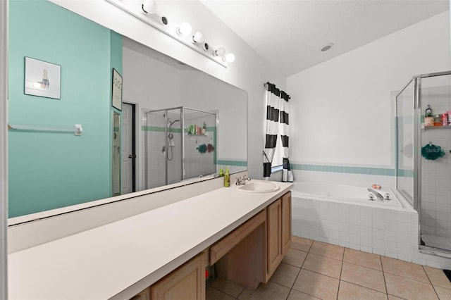 full bathroom featuring a stall shower, a garden tub, vanity, and tile patterned floors