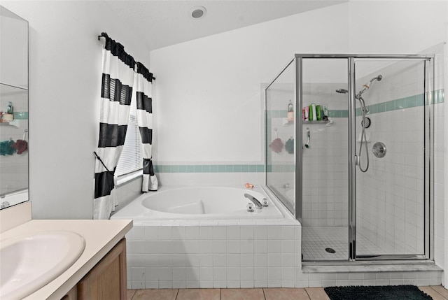 bathroom with a shower stall, a garden tub, vanity, and tile patterned floors