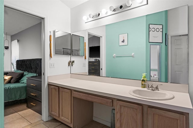 bathroom with tile patterned flooring, connected bathroom, and vanity