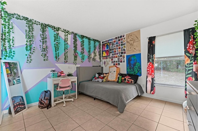 bedroom featuring light tile patterned floors and baseboards