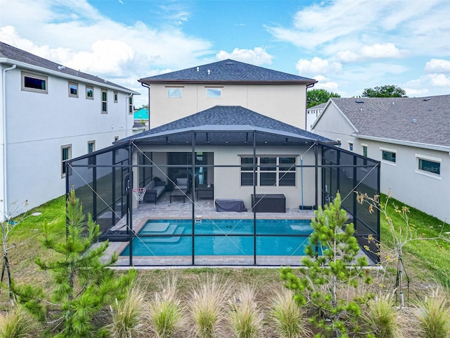 rear view of house featuring a shingled roof, a fenced in pool, a patio, glass enclosure, and stucco siding