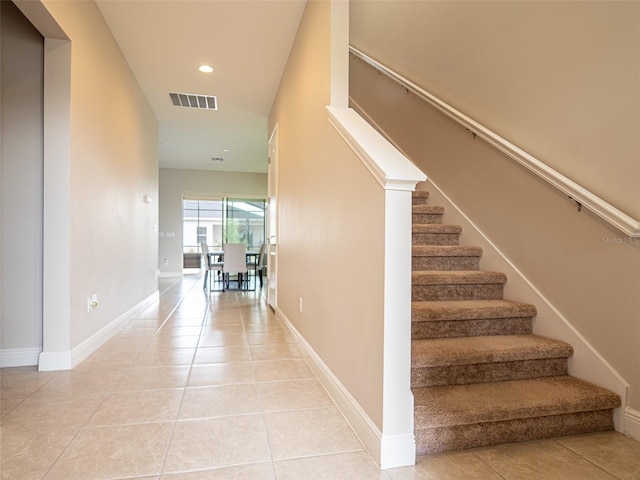 stairs featuring tile patterned flooring, visible vents, baseboards, and recessed lighting