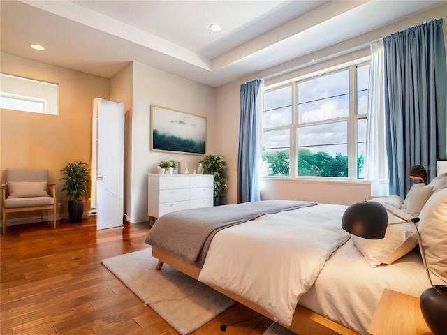 bedroom with dark wood-style floors, recessed lighting, and baseboards