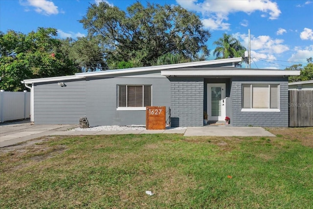 rear view of property with a yard and fence