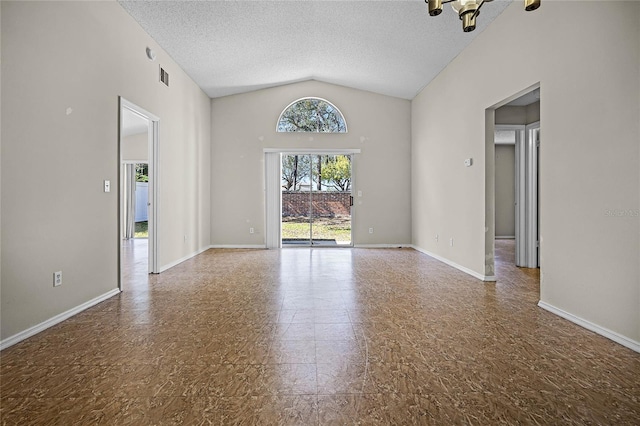 empty room featuring visible vents, vaulted ceiling, a textured ceiling, and baseboards