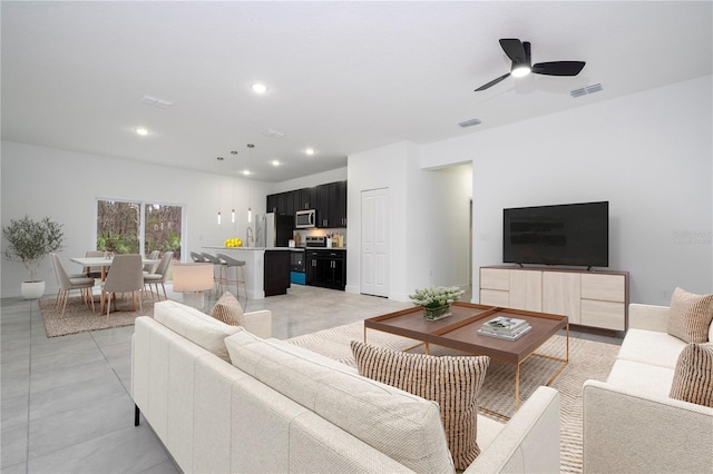 living room with recessed lighting, visible vents, baseboards, and ceiling fan