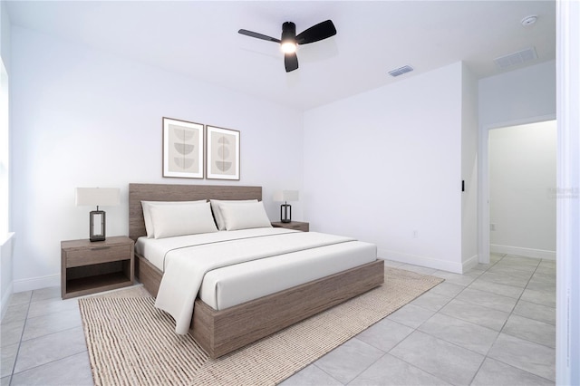 bedroom with light tile patterned floors, visible vents, and baseboards