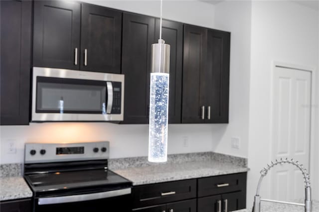kitchen featuring appliances with stainless steel finishes and dark cabinets