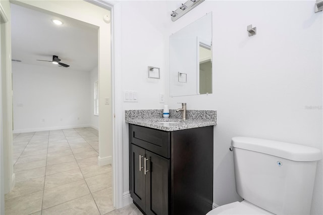 half bath featuring vanity, a ceiling fan, baseboards, tile patterned flooring, and toilet