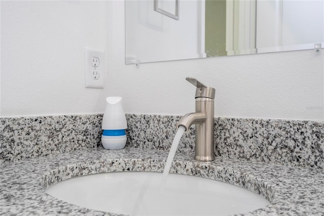 room details featuring a sink and tasteful backsplash