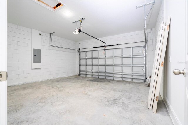 garage with electric panel and a garage door opener