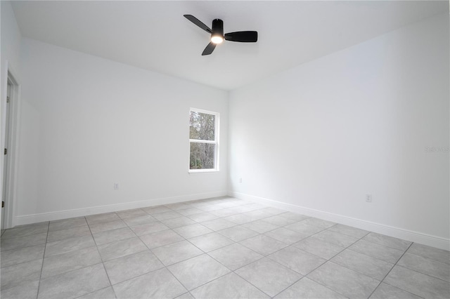 unfurnished room featuring a ceiling fan and baseboards