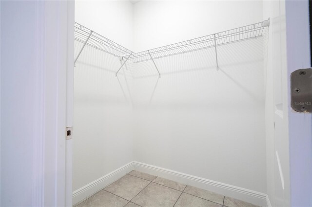 spacious closet with light tile patterned floors