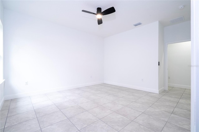 empty room with visible vents, baseboards, and ceiling fan
