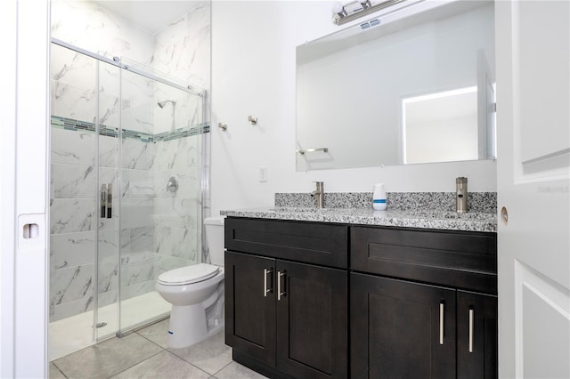 bathroom featuring visible vents, toilet, a sink, a marble finish shower, and double vanity