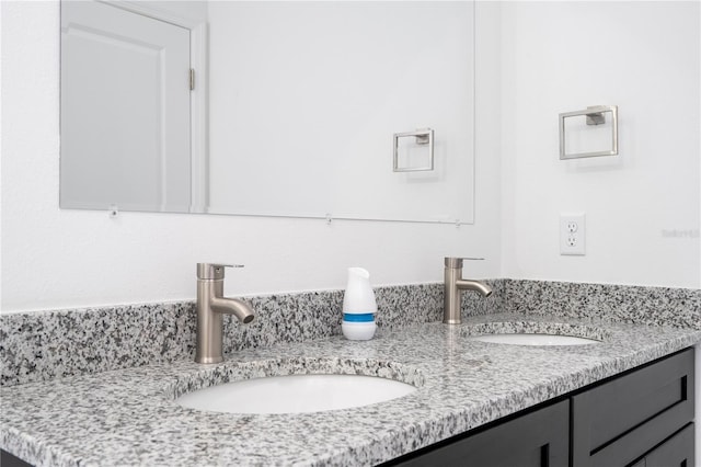 full bathroom featuring a sink and double vanity