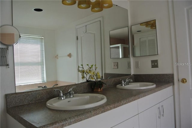 full bath with double vanity and a sink