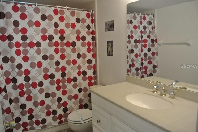 full bathroom with toilet and vanity