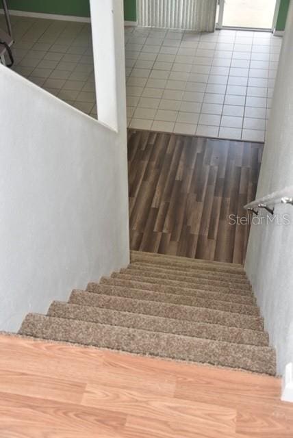 staircase featuring tile patterned flooring