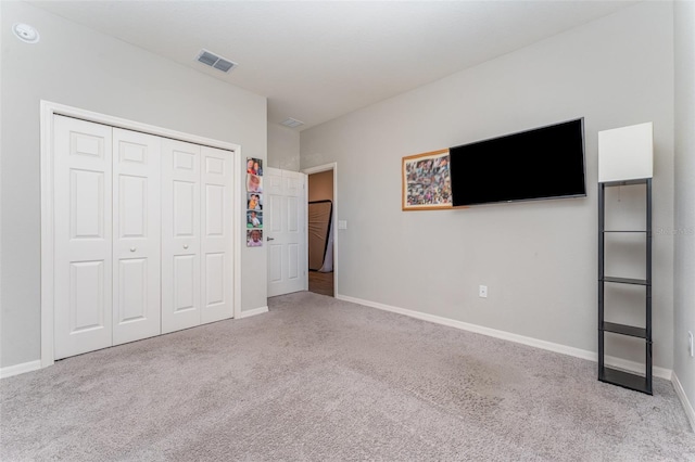 unfurnished bedroom with carpet, baseboards, and a closet