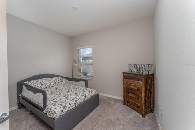 bedroom with carpet flooring and baseboards