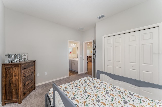 bedroom with carpet flooring, baseboards, a closet, and ensuite bath
