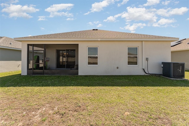 back of house with cooling unit, a sunroom, a lawn, and stucco siding