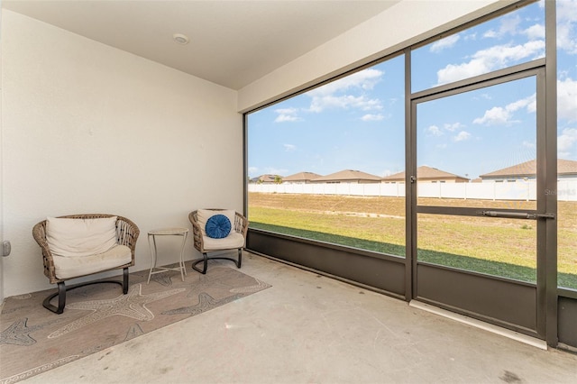 unfurnished sunroom with plenty of natural light and a residential view