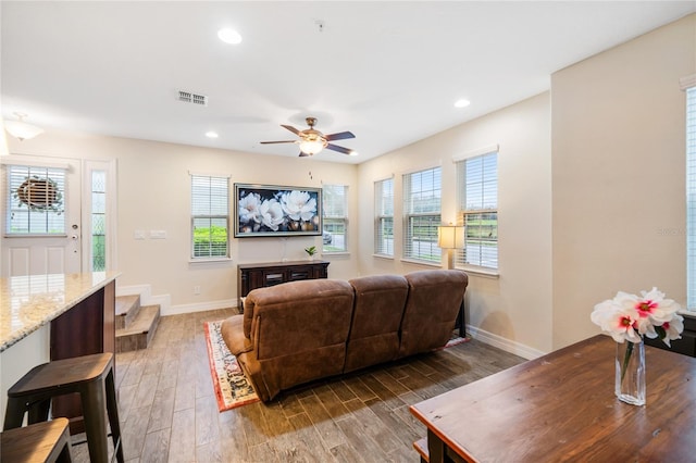 living area featuring dark wood finished floors, recessed lighting, visible vents, a ceiling fan, and baseboards