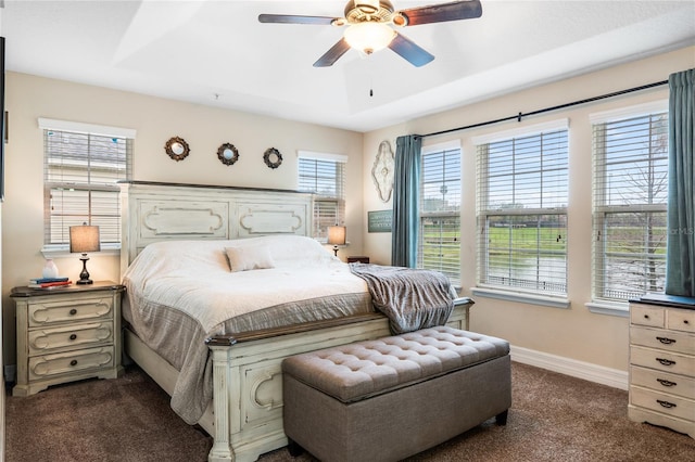 carpeted bedroom with ceiling fan and baseboards