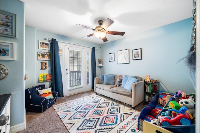 living area with light carpet and ceiling fan