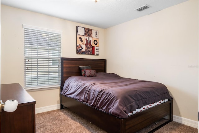 bedroom featuring light colored carpet, visible vents, and baseboards