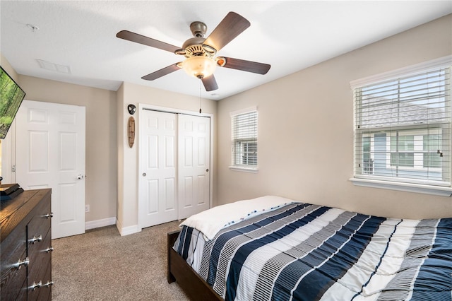 bedroom with multiple windows, visible vents, a closet, and light colored carpet