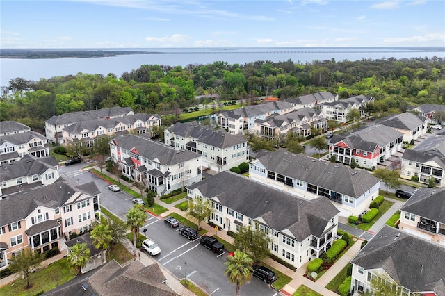 drone / aerial view featuring a water view and a residential view