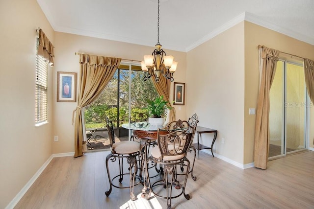 dining space featuring baseboards, a healthy amount of sunlight, a notable chandelier, and light wood-style floors