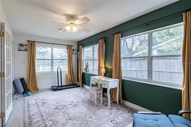 interior space featuring a ceiling fan and baseboards