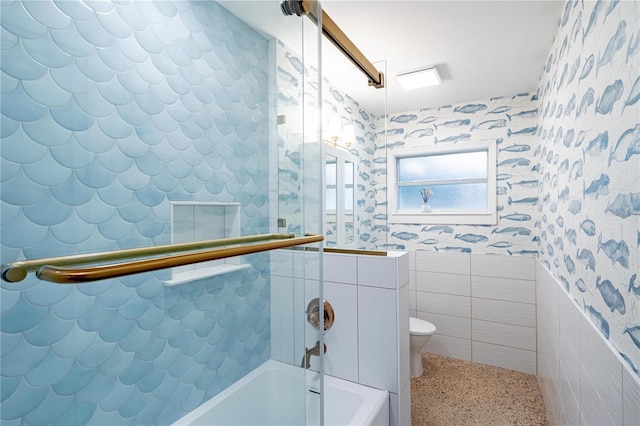 bathroom featuring wallpapered walls, tile walls, toilet, and speckled floor